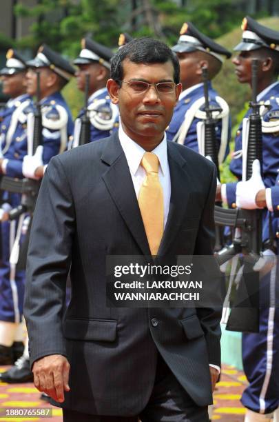 Maldivian Democratic Party founder and newly sworn in President Mohamed 'Anni' Nasheed inspects a Maldives National Defence Force Honour Guard in a...