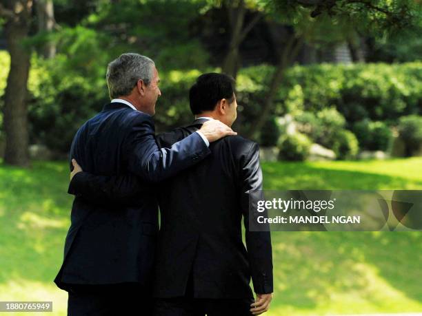 President George W. Bush and South Korean President Lee Myung-bak leave a joint press conference at the presidential Blue House in Seoul on August 6,...