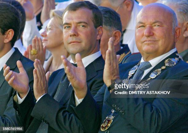 Russian President Dmitry Medvedev and Moscow Mayor Yury Luzhkov applaud on September 7, 2008 in Moscow during celebrations for the 861st anniversary...