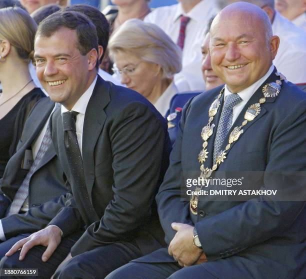Russian President Dmitry Medvedev sits near Moscow Mayor Yury Luzhkov in Moscow on September 7 during celebrations for the 861st anniversary of the...