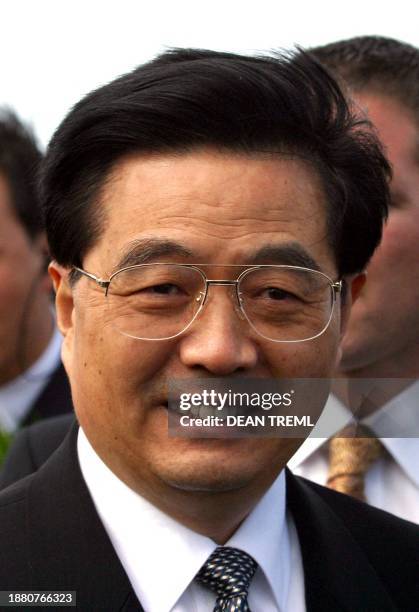 Chinese President Hu Jintao smiles to the press upon his arrival at Wellington International Airport, Wellington, New Zealand. 25 October 2003....