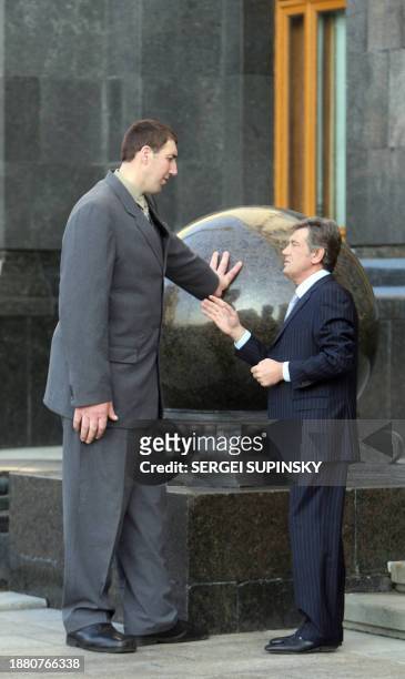 President of Ukraine Viktor Yushchenko speaks to Leonid Stadnik who at 2.59 metres tall, is the world's tallest living man, at the Presidential...