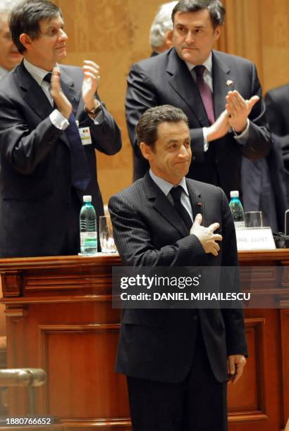 French President Nicolas Sarkozy puts his hand on the heart after he delivers his speech to the Romanian Parliament shortly before the Parliament...