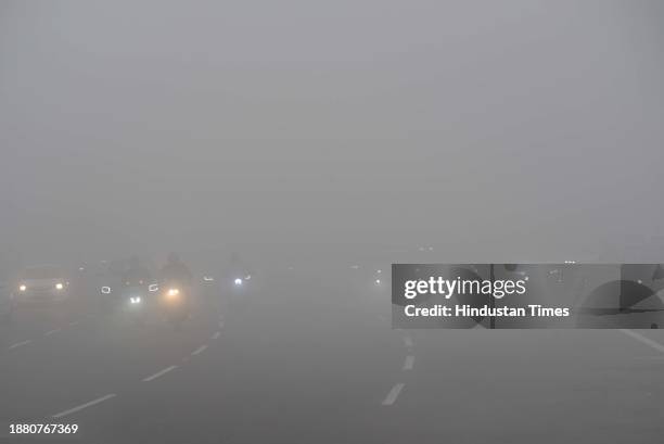 Vehicle plying slow speed amid dense foggy weather at NH-48 South West Delhi near Rajokri Village on December 27, 2023 in New Delhi, India. Dense fog...