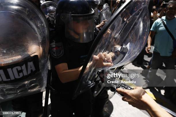 Police officers advance against the press with shield blows the police mounted a large operation with several national and federal forces provided by...