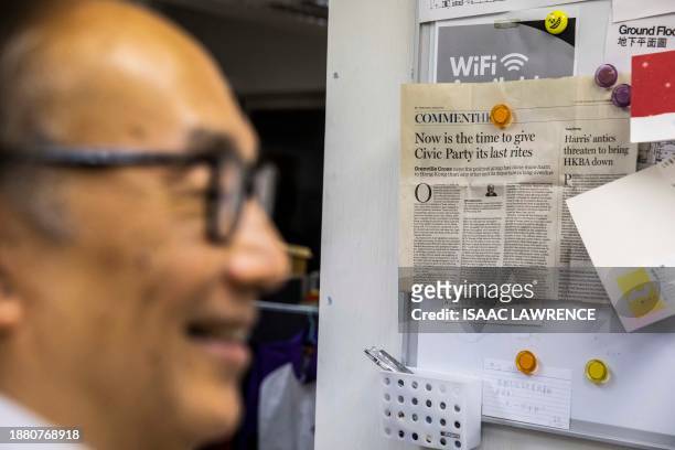 This photo taken on August 3, 2023 shows a newspaper clipping on a whiteboard past veteran politician Alan Leong at the Civic Party headquarters,...
