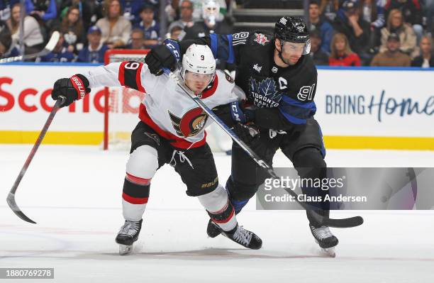 Josh Norris of the Ottawa Senators draws an interference penalty against John Tavares of the Toronto Maple Leafs during the second period at...