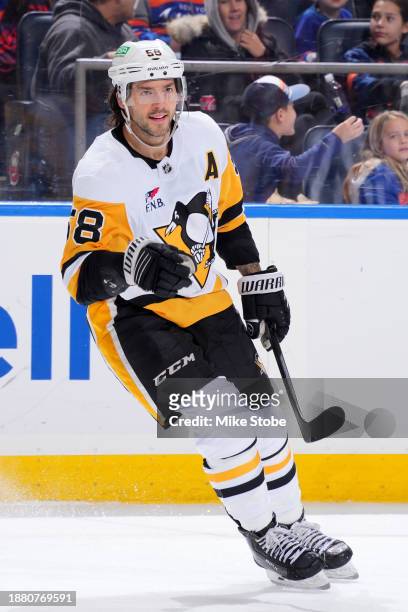 Kris Letang of the Pittsburgh Penguins reacts after an assist on a goal by teammate Evgeni Malkin against the New York Islanders during the second...