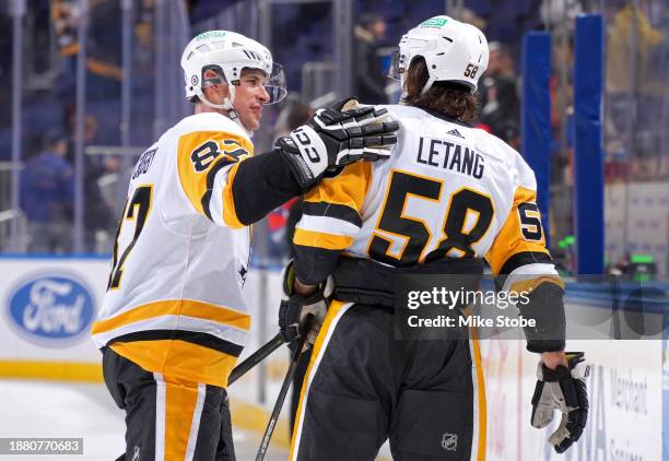 Kris Letang and Sidney Crosby of the Pittsburgh Penguins celebrate their 7-0 win against the New York Islanders at UBS Arena on December 27, 2023 in...
