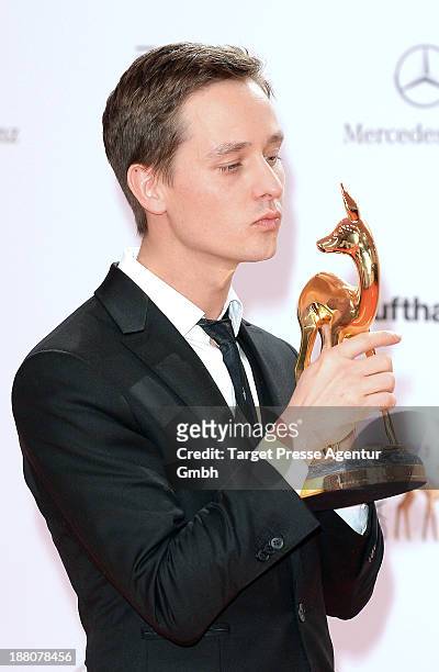 Tom Schilling poses with the Bambi for best actor at Stage Theater on November 14, 2013 in Berlin, Germany.