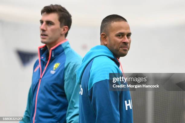 Pat Cummins and Usman Khawaja watch on during an Australian Test squad nets session at Melbourne Cricket Ground on December 25, 2023 in Melbourne,...