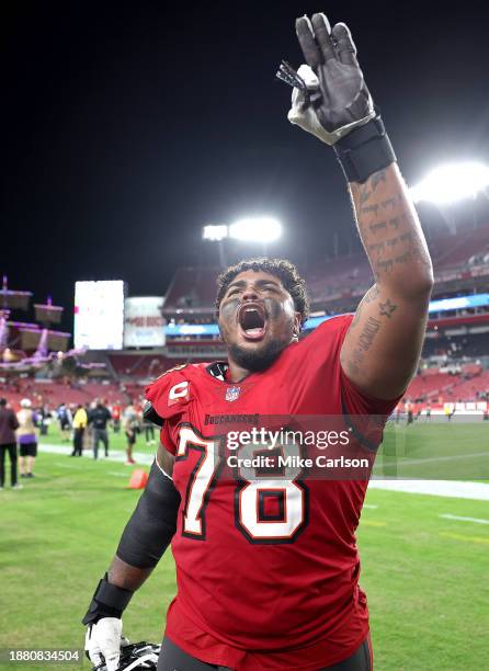 Tristan Wirfs of the Tampa Bay Buccaneers celebrates the 30-12 win against the Jacksonville Jaguars at Raymond James Stadium on December 24, 2023 in...