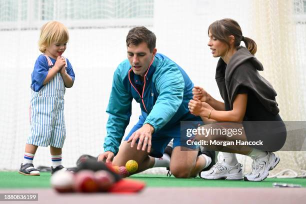 Pat Cummins and Becky Cummins interact with their child, Albie during an Australian Test squad nets session at Melbourne Cricket Ground on December...