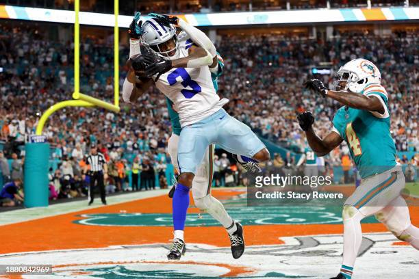 Brandin Cooks of the Dallas Cowboys scores a touchdown during the fourth quarter while defended by Jalen Ramsey and Kader Kohou of the Miami Dolphins...