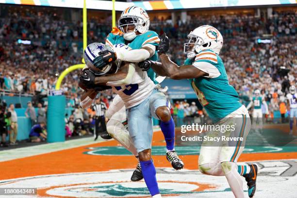 Brandin Cooks of the Dallas Cowboys scores a touchdown during the fourth quarter while defended by Jalen Ramsey and Kader Kohou of the Miami Dolphins...