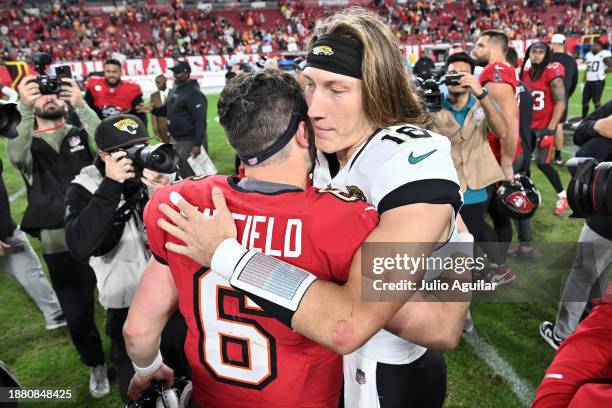 Trevor Lawrence of the Jacksonville Jaguars and Baker Mayfield of the Tampa Bay Buccaneers meet on the field after the Buccaneers 30-12 win at...