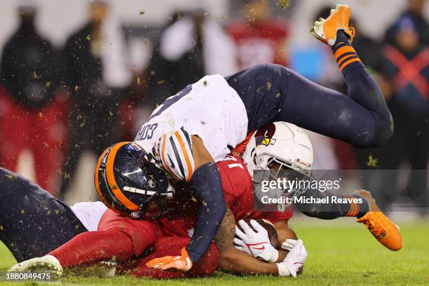 Kyler Gordon of the Chicago Bears tackles Emari Demercado of the Arizona Cardinals during the fourth quarter at Soldier Field on December 24, 2023 in...