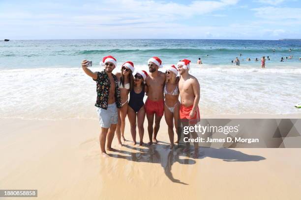 People gather on Bondi Beach to celebrate Christmas Day on December 25, 2023 in Sydney, Australia. Hundreds gathered early on the world famous beach...