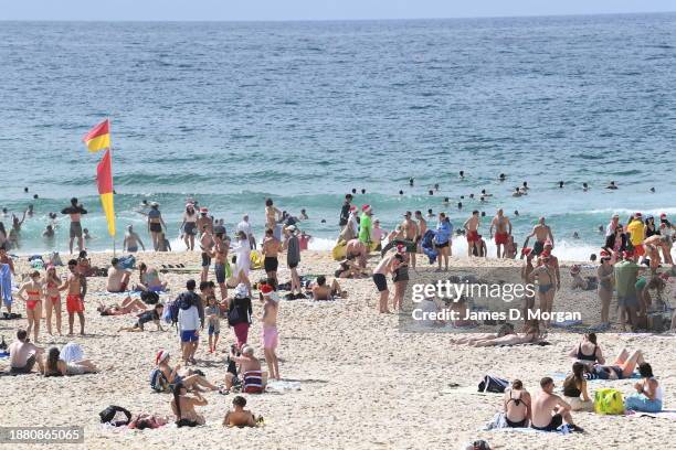 People gather on Bondi Beach to celebrate Christmas Day on December 25, 2023 in Sydney, Australia. Hundreds gathered early on the world famous beach...