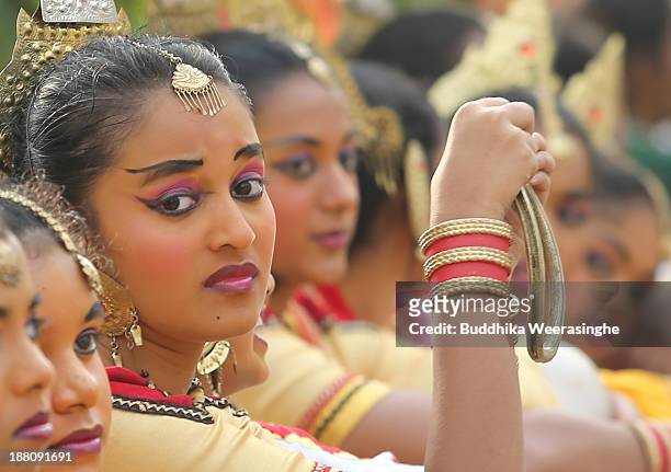 Sri Lankan school students wait to perform traditional dance out side the Nelum Pokuna Mahinda Rajapakse Theatre during the CHOGM oppening ceremony...