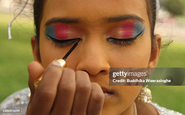 Sri Lankan school student prepares to perform traditional dance out side the Nelum Pokuna Mahinda Rajapakse Theatre during the CHOGM oppening...