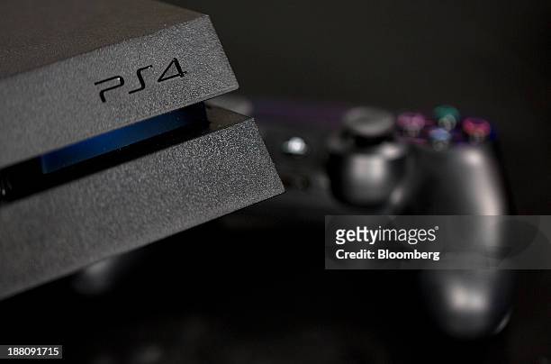 Logo sits on the front of a Sony PlayStation 4 games console, manufactured by Sony Corp., in this arranged photograph taken in London, U.K., on...