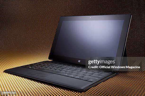 Microsoft Surface Pro tablet PC with a keyboard photographed on a metallic mesh background, taken on April 4, 2013.