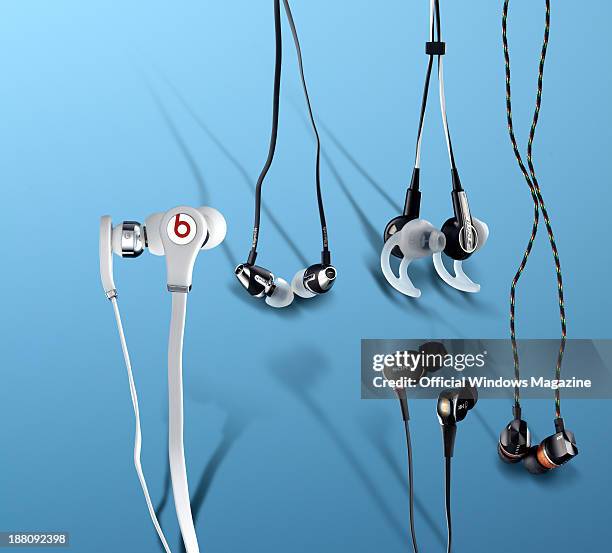 Selection of in-ear headphones photographed on a blue background, including Beats by Dre Tour, Klipsch Image S4A, Bose IE2, Sony XBA-3 and House of...