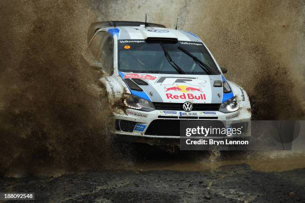 Sébastien Ogier and Julien Ingrassia of France drive the Volkswagen Polo R WRC through a watersplash on the Sweet Lamb stage of the FIA World Rally...