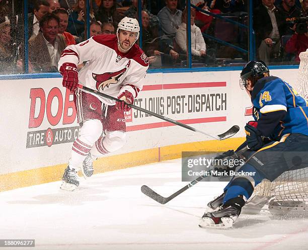 Keith Yandle of the Phoenix Coyotes skates against T.J. Oshie of the St. Louis Blues on November 12, 2013 at Scottrade Center in St. Louis, Missouri.