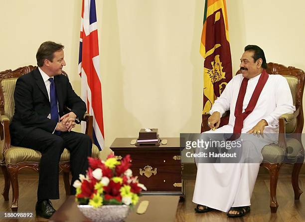 In this handout photo provided by Sri Lankan Government, Sri Lankan President Mhainda Rajapaksa speaks with United Kingdom Prime Minister, David...