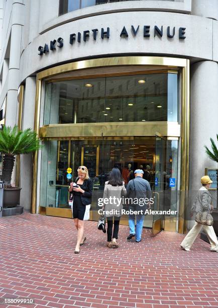 Shoppers leave and enter the Saks Fifth Avenue store in San Francisco's upscale Union Square shopping district.