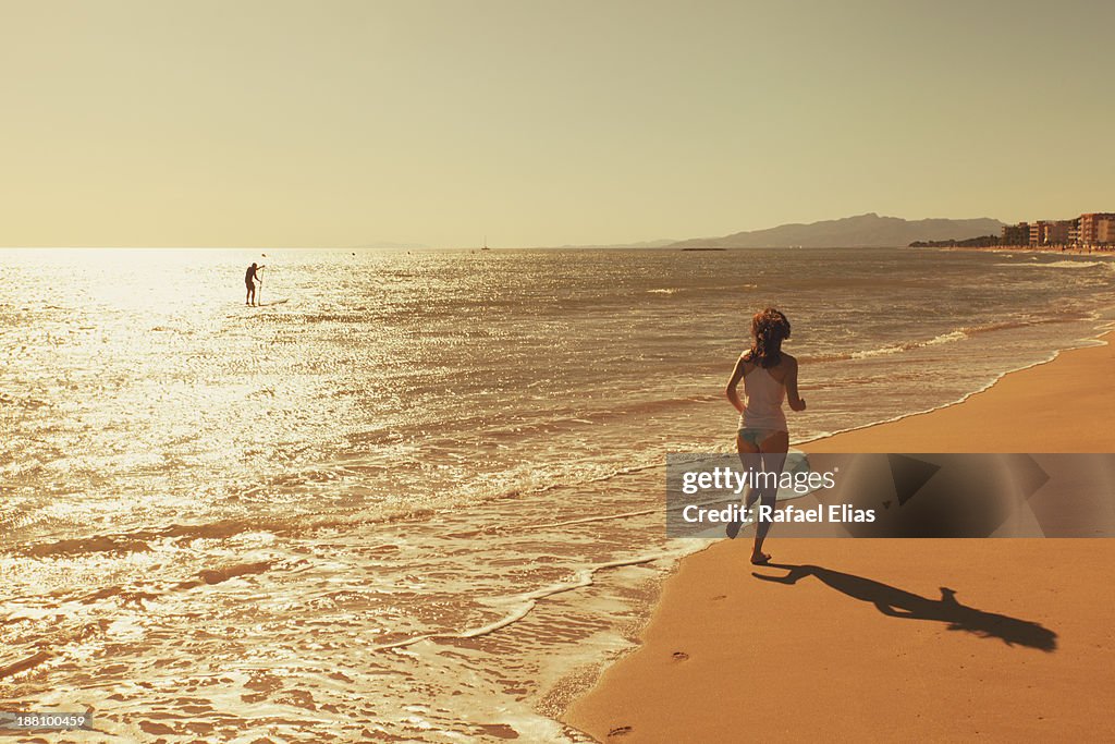 Woman running at sea shore