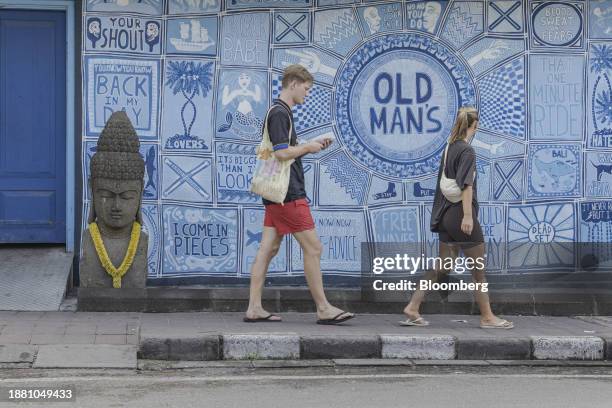 Visitors walk past a bar in Canggu, Bali, Indonesia, on Thursday, Dec. 28, 2023. Indonesia plans to let more nationalities enter the country without...