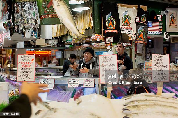 Fish monger tosses salmon at Pike Place Market in Seattle, Washington, U.S., on Wednesday, Nov. 13, 2013. The dollar strengthened to a two-month high...