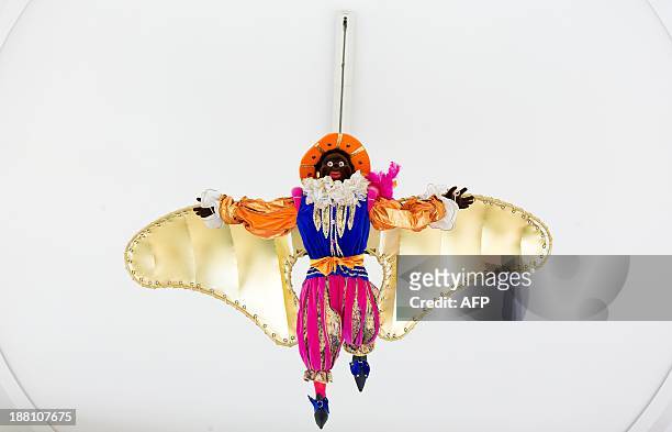 Decorative Zwarte Piet 'flies' in a department store in The Hague, The Netherlands, on November 15, 2013. Zwarte Piet is, as part of the Dutch...