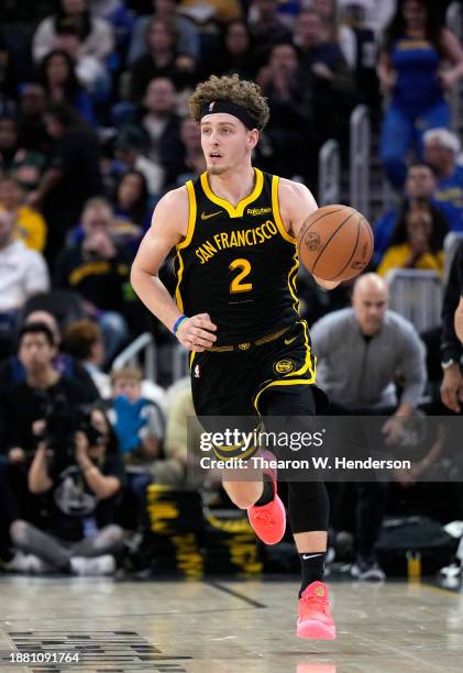 Brandin Podziemski of the Golden State Warriors dribbles the ball up court against the Portland Trail Blazers during the second half of an NBA...