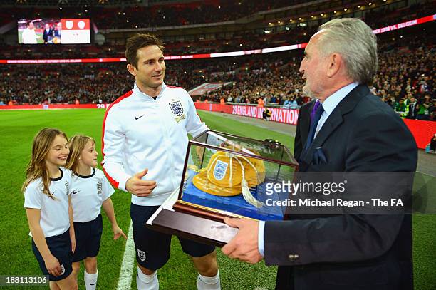 Frank Lampard of England receives his 100th cap that he won at FIFA 2014 world cup qualifier between Ukraine and England from his father Frank...