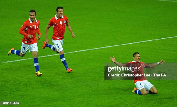 Alexis Sanchez of Chile celebrates scoring their first goal with Eduardo Vargas and Mauricio Isla during the International Friendly match between...