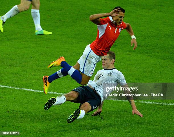 Jack Wilshere of England tackles Alexis Sanchez of Chile during the International Friendly match between England and Chile at Wembley Stadium on...