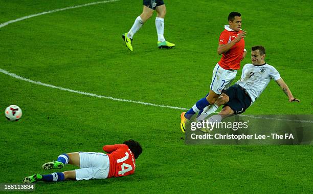 Jack Wilshere of England tackles Alexis Sanchez of Chile during the International Friendly match between England and Chile at Wembley Stadium on...