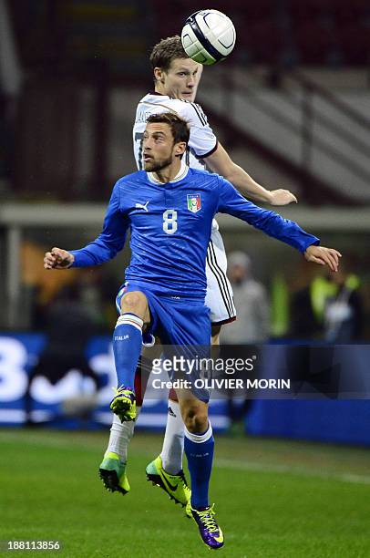 Italy's midfielder Claudio Marchisio jumps for the ball with Germany's midfielder Marcell Jansen during the FIFA World Cup friendly football match...