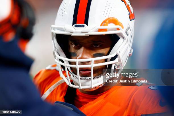 Quarterback Russell Wilson of the Denver Broncos talks with coaches during a timeout in the 2nd quarter of the game against the New England Patriots...