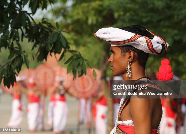 Sri Lankan dancers wait to perform front of the Nelum Pokuna Mahinda Rajapakse Theatre during the CHOGM oppening ceremony on November 15, 2013 in...