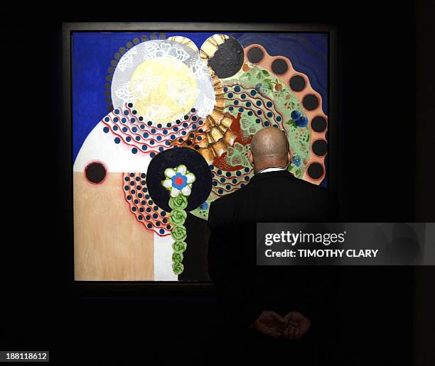 Man looks at "O casamento" by Beatriz Milhazes during a media preview on November 15, 2013 at Christie's New York for their Latin American Art...