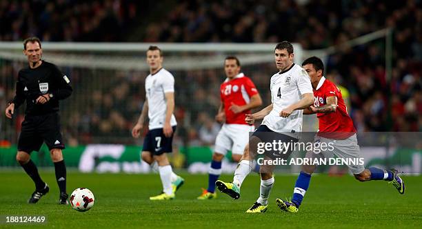 England's James Milner passes the ball during the international friendly football match between England and Chile at Wembley in north London on...