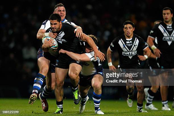 Jesse Bromwich of New Zealand is tackled by Ben Kavanagh and Adam Walker of Scotland during the Rugby League World Cup Quarter Final match at...