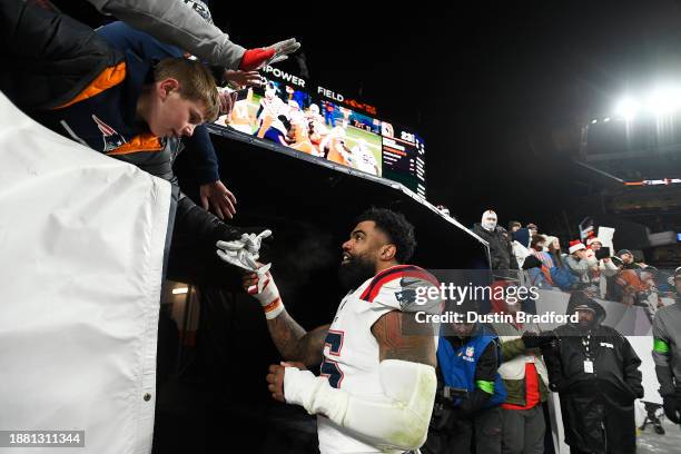 Running back Ezekiel Elliott of the New England Patriots greets fans after the New England Patriots defeated the Denver Broncos 26-23 to win the game...