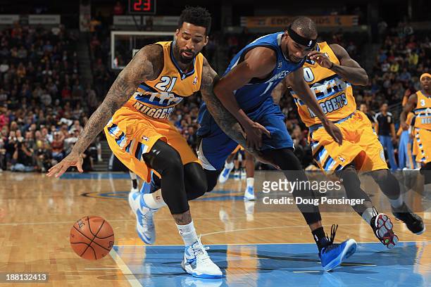 Wilson Chandler of the Denver Nuggets grabs a loose ball away from Corey Brewer of the Minnesota Timberwolves at Pepsi Center on November 15, 2013 in...
