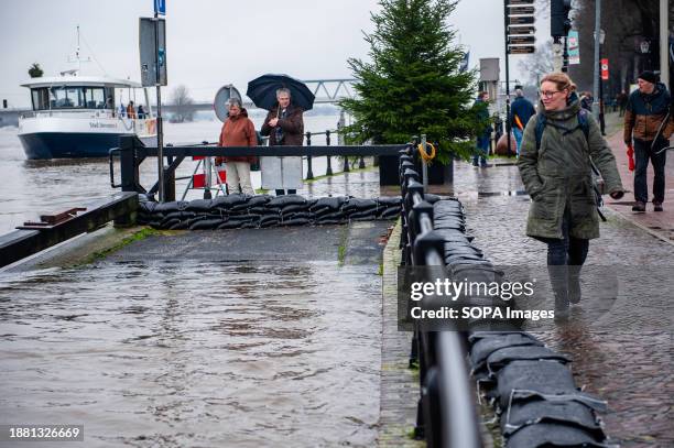 People are seen looking at the sandbags placed along the river to protect the city. Due to the rising water in the IJssel River, the municipality of...